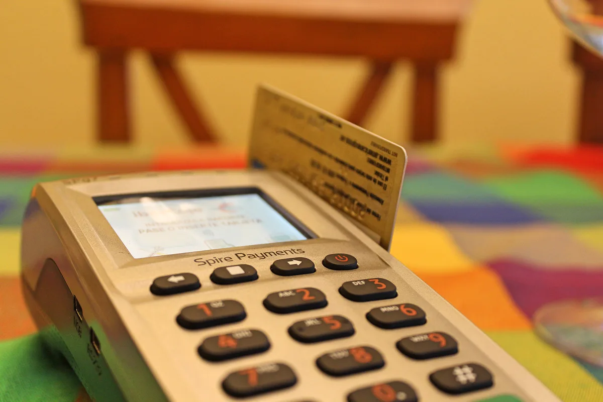 Bank card inserted into a retail payment terminal.