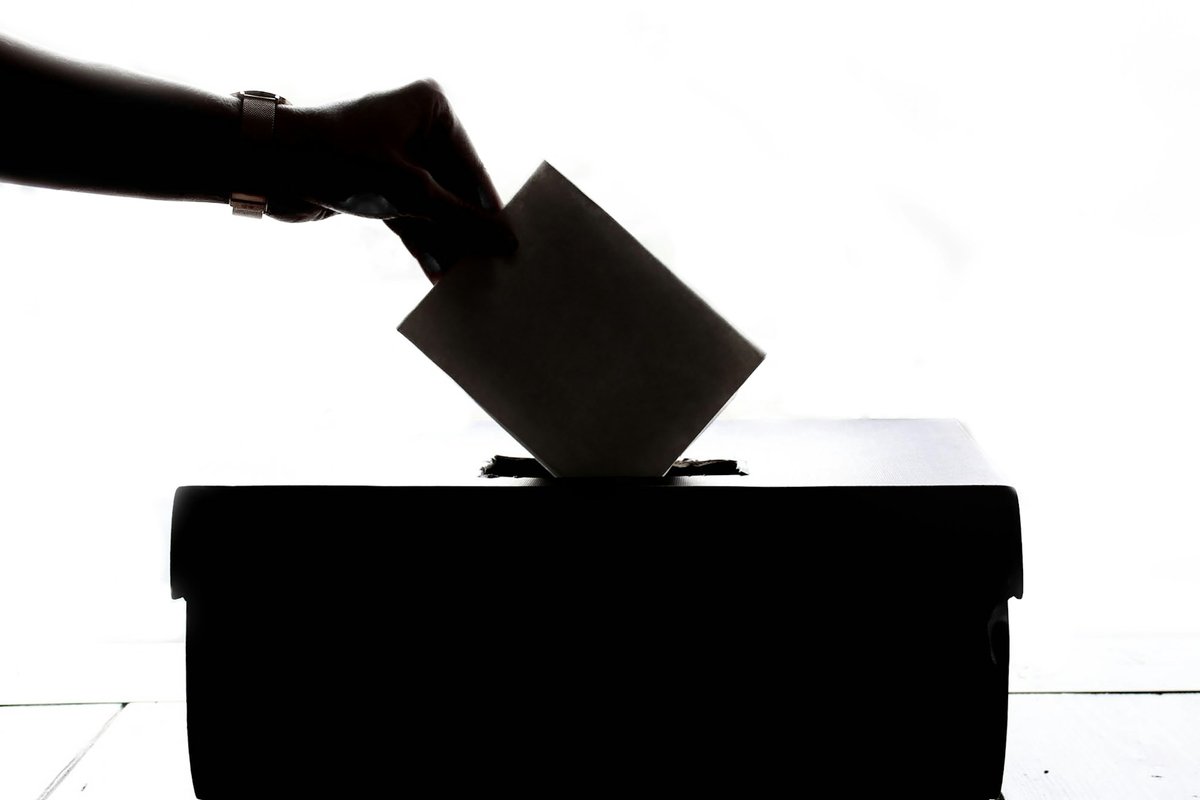 A ballot being placed in a box