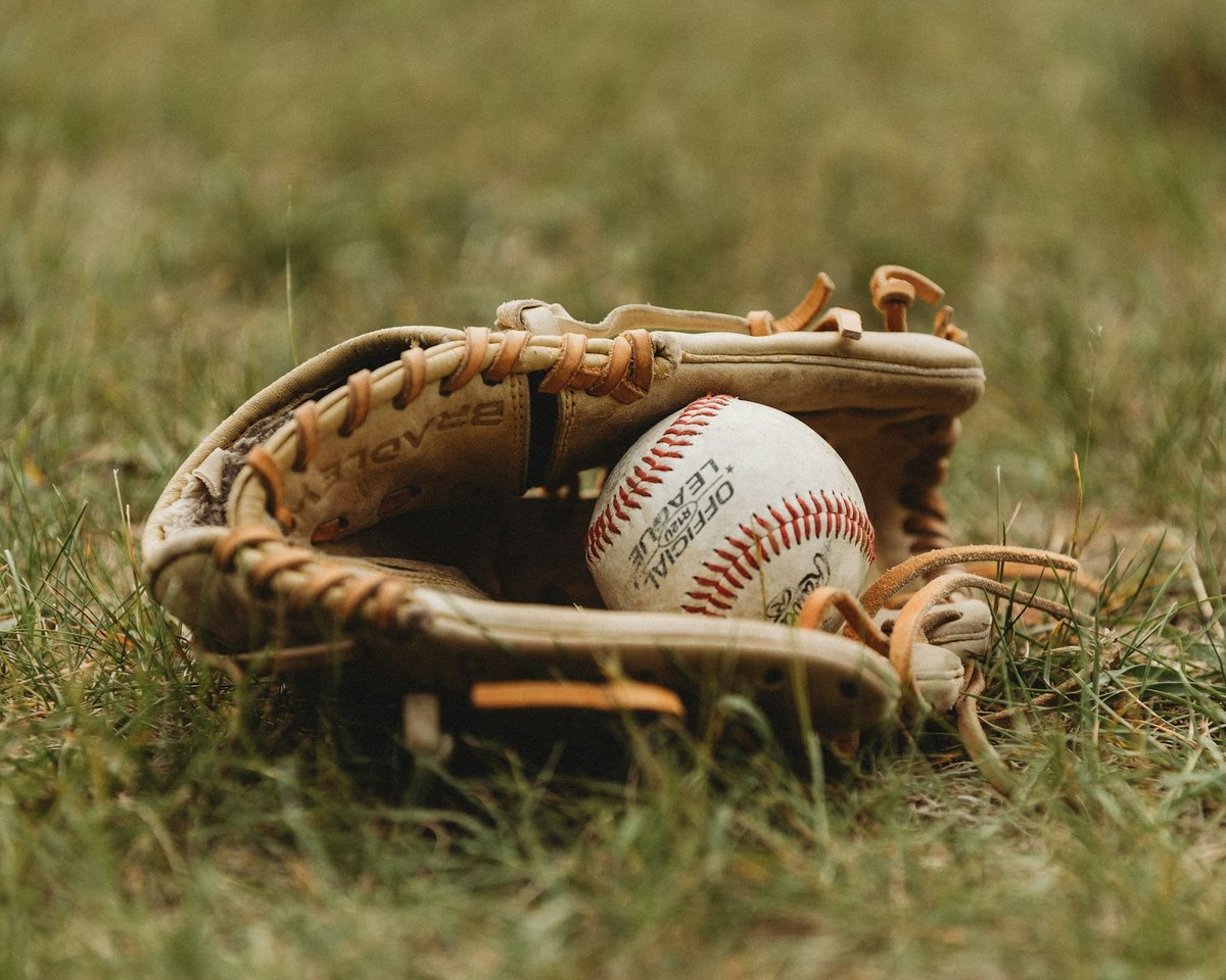 Baseball and mitt on grass